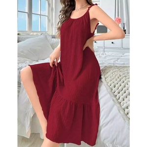Detail of burgundy spaghetti strap loungewear dress with ruffled hem and pleated texture