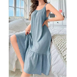 Detail of light blue striped sleepwear fabric and ruffled hemline in bedroom setting