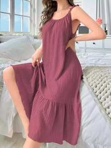 Detail of ruffle hem and ribbed texture on the sleeveless lotus pink loungewear dress