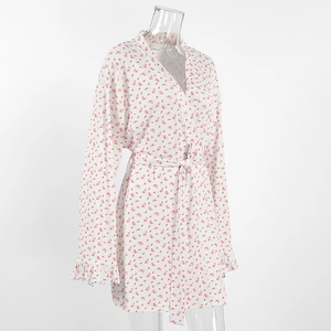 Detail view of white floral knit robe with pink flower prints and ruffled sleeve cuffs