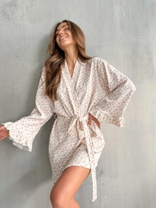Detail view of floral knit robe featuring ribbed texture, belted waist and ruffle sleeves