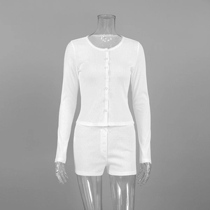 Close-up of white knitted jacquard sleepwear showing lace trim and ribbed texture detail