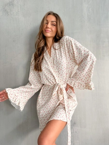 Detail of floral knit robe featuring ruffled cuffs and ribbed texture fabric
