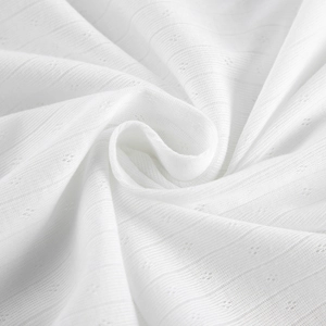 Close-up of white knit pointelle fabric texture with breathable diamond eyelets