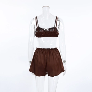 Rear view of brown satin sleepwear set with camisole top and ruffled high-waist shorts