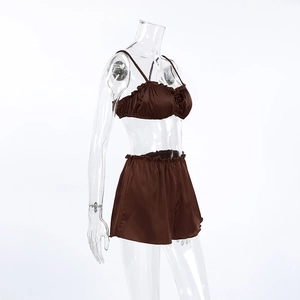 Detail of dark brown satin lingerie set with ruffled hem and adjustable spaghetti straps