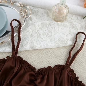 Detail of coffee satin camisole top with elegant ruffled edges and silk-like finish
