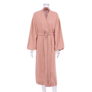 Detailed texture of pink double-layer cotton gauze bathrobe with waist belt and cuffs