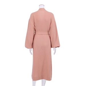 Detail view of coral pink double-layer cotton robe back texture with matching waist belt