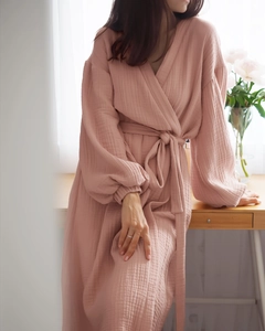 Detail of soft cotton double gauze texture on a pink V-neck bathrobe with belt