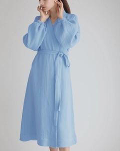 Detail of light blue double-layer cotton gauze bathrobe with tied waist and V-neckline