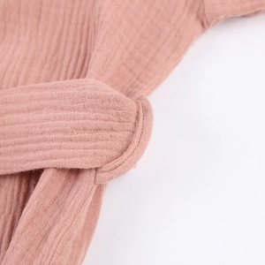 Close-up of pink double gauze cotton bathrobe showing waistband loop and fabric texture