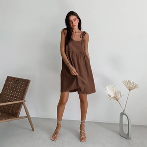 Detail of dark brown cotton linen sundress featuring delicate shoulder ties and ruched waist