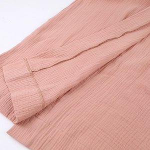 Detailed macro view of pure cotton double-layer gauze sleeve with double-stitched hem