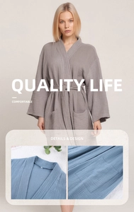 Detail of soft crepe cotton bathrobe with kimono collar and textured fabric weave