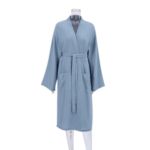 Detail of greyish blue cotton crepe bathrobe with textured fabric and front pockets