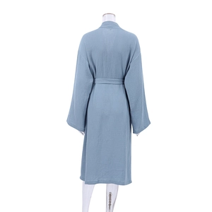 Detail of light blue crepe cotton bathrobe texture and adjustable waist tie design