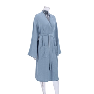 Detailed texture of dusty blue cotton crepe bathrobe with waist tie and side pockets
