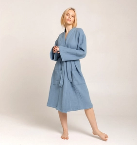 Detail view of steel blue muslin cotton bathrobe showing texture and large front pockets