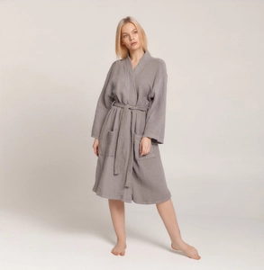 Detailed texture of grey crinkle cotton bathrobe with kimono V-neck and waist tie