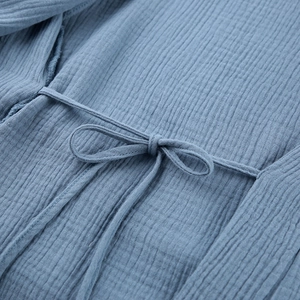 Detailed macro view of crinkle cotton sleepwear with drawstring waist and texture