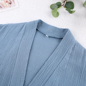 Close-up of V-neck cotton muslin robe with textured crinkle fabric in dark grey blue