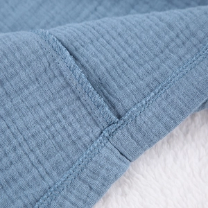 Detailed close-up of blue crepe cotton robe showing premium stitching and soft texture