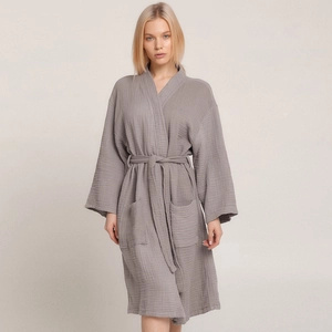 Smoky grey cotton crepe kimono bathrobe with tie waist and front pockets in a studio shot
