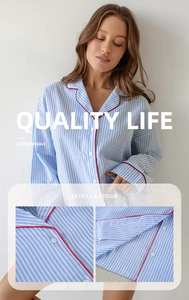 Detail of blue striped cotton pajama top featuring red contrast piping and buttoned collar