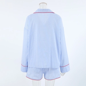 Detail view of cotton striped pajama set with red piping on long sleeves and shorts back