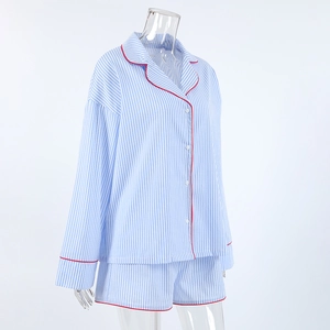 Detail view of cotton striped pajama set with red piping on collar and cuffs