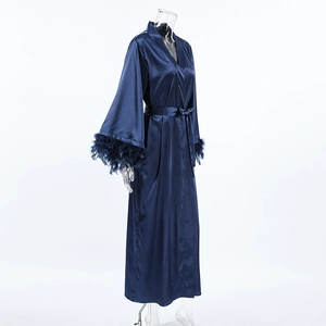Close-up of deep blue satin robe featuring luxurious feather trim on long sleeves