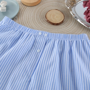 Detailed macro view of blue and white striped cotton pajama shorts with elastic waistband