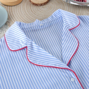 Close-up of blue striped cotton pajama top with red piping and size L label details