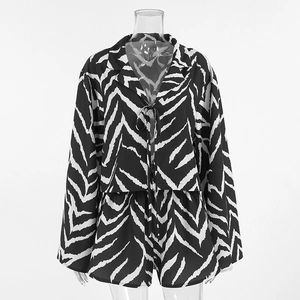 Detail of zebra print pajama set featuring tie-front long sleeve top and loose shorts