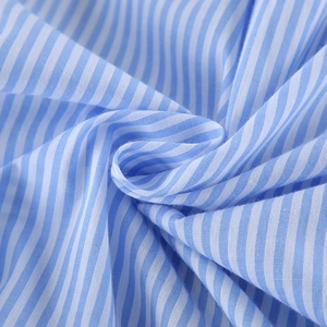 Close-up of blue and white striped cotton fabric showing soft texture and fine weave