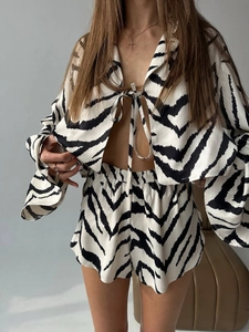 Detailed view of zebra print long sleeve top and elastic shorts with silky texture