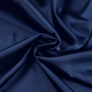 Detailed texture of navy blue satin fabric with elegant drape and silky smooth finish