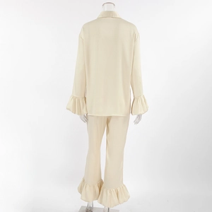 Detail view of the elegant satin pajama set with wide ruffle cuffs and hem on the back