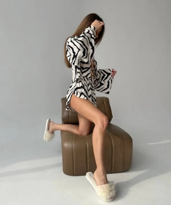 Detailed view of women's zebra print pajamas with stylish flared sleeves and soft fabric