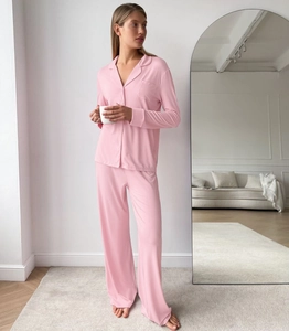 Side view of pink modal long sleeve pajama set with button-up top and wide leg pants