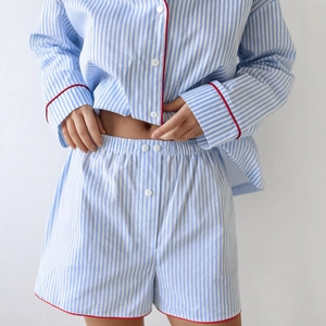 Women's blue and white striped cotton pajama set with red piping and button-up front