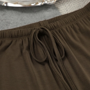 Detail of modal pajama trousers featuring an elastic waistband with adjustable drawstring