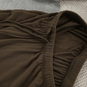 Detail of modal pajamas showing elastic waistband and adjustable drawstring in dark brown