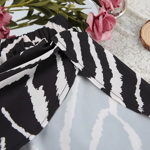 Detail view of black and white zebra print shorts featuring elastic waist and side tie detail