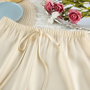Detail of satin pajama waistband with elastic and drawstring in an elegant setting