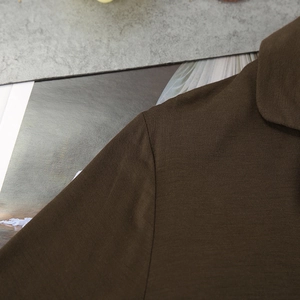Close-up of the dark brown modal fabric texture on the collar and shoulder of the pajama set
