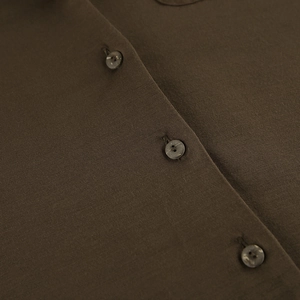 Close-up of brown knit pajama top featuring marble-textured buttons and soft fabric