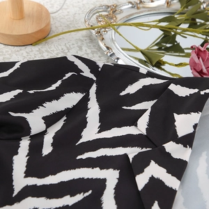 Detailed view of black and white zebra print fabric and collar of the pajama set