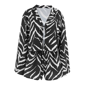 Women's zebra print pajama set featuring long sleeve tie-front top and matching shorts
